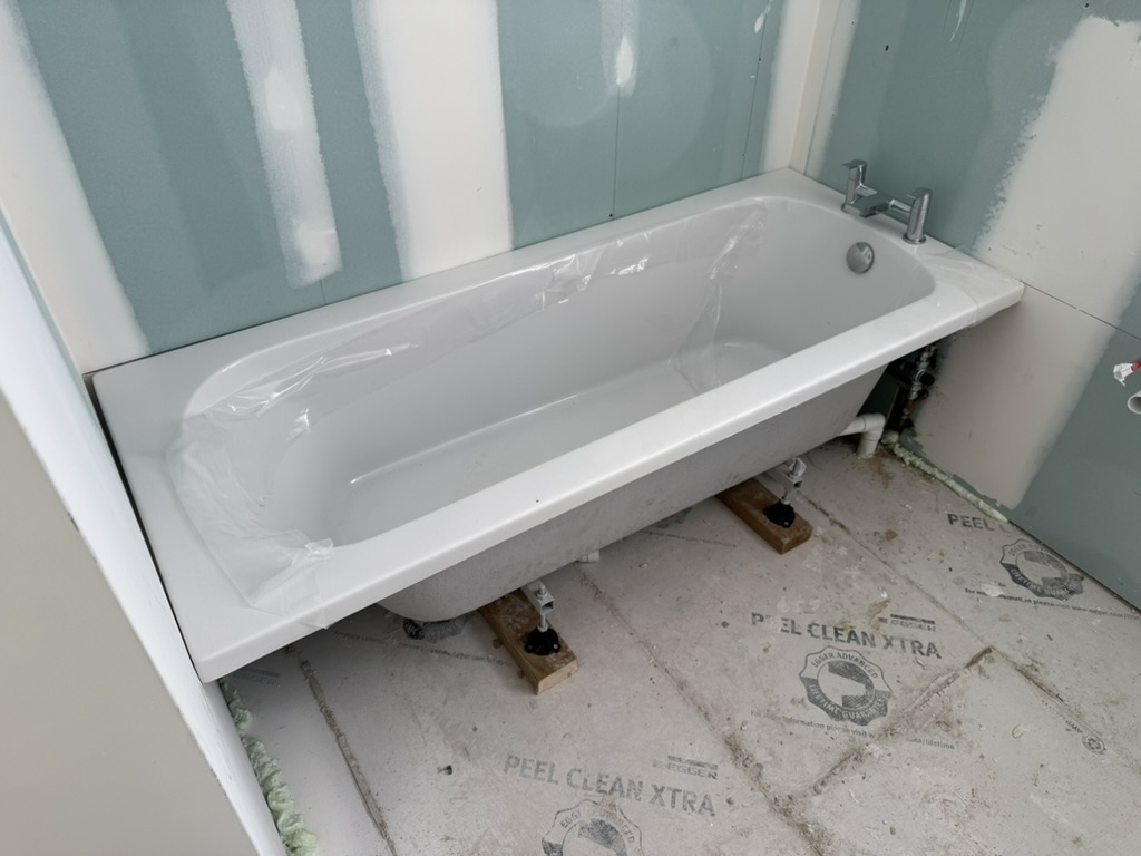 New white bath fitted during a bathroom renovation